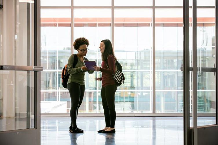 Two students talk in a building on Fort Omaha Campus